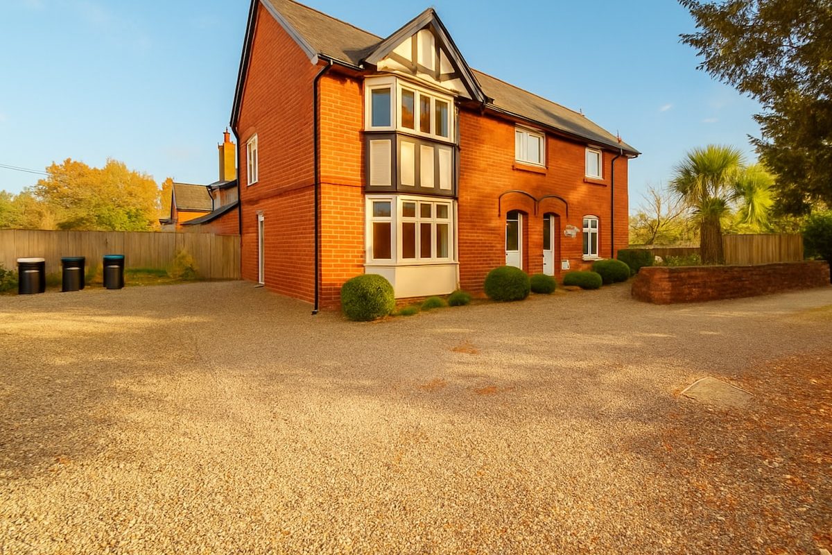 Detached red-brick five-bedroom house with large private gravel parking in Pulford, Chester